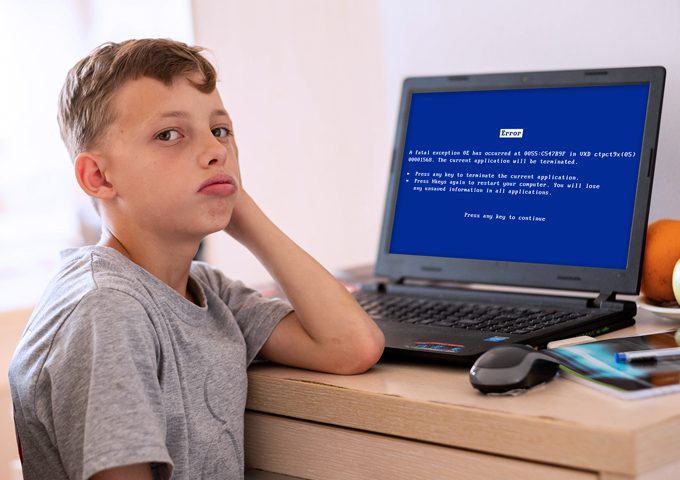 Gem-Systems-boy-with-computer-error-on-computer